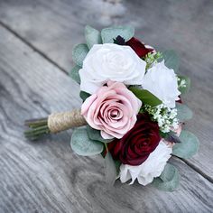 a bridal bouquet sitting on top of a wooden table