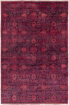 an antique rug with red and purple colors