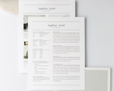 two resumes sitting next to each other on top of a white table with papers