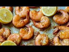 cooked shrimp with lemons and spices on a baking sheet, ready to be eaten