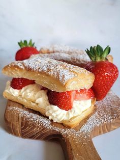 strawberry shortcakes with powdered sugar and fresh strawberries on the top are ready to be eaten