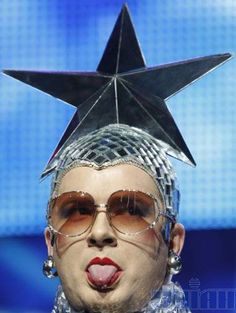 a close up of a person wearing glasses and a star on top of their head