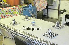 the table is decorated with black and white chevron paper napkins, centerpieces