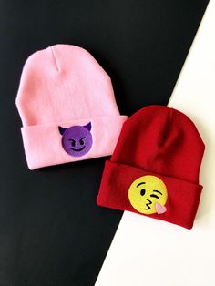 two beanies with faces on them sitting next to each other