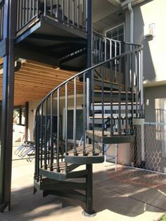 a spiral staircase in front of an apartment building