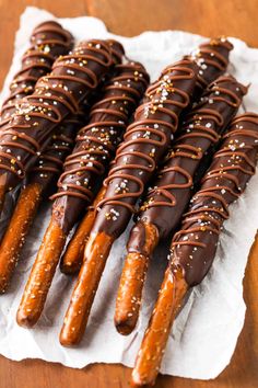 chocolate covered pretzels are lined up on a napkin