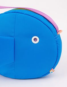 Find a new friend in this super plushy Fish Purse! This bag is so comfy and soft to wear, you'll be making it your daily driver. The inside is super roomy and can fit everything you need. Store small items in the two inside pockets. The grommet eye is the perfect size to thread your phone charger through to keep your phone charged and on hand! Hang your keys or our matching Fish Keychains off the double zipper pulls or the paracord loops on the head & tail of the bag. Adjust the strap to your pe Playful Blue Bag With Adjustable Strap, Playful Blue Shoulder Bag For Travel, Functional Backpack For Playtime, Playful Shoulder Bag With Removable Pouch, Playful Blue Pouch Bags, Functional Playtime Standard Backpack, Fish Keychains, Fish Purse, Bike Seat Bag