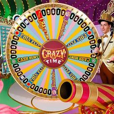 a man standing next to a wheel of fortune in front of a carnival ride sign