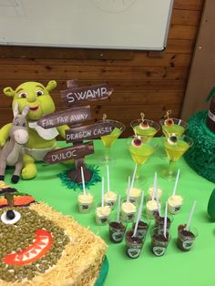 a green table topped with lots of desserts