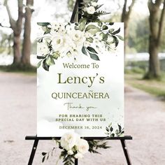 a welcome sign with white flowers on it