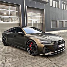 a grey car parked in front of a building