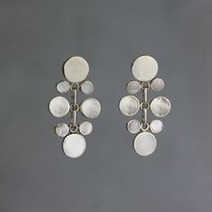 Serene discs of white and silver link together in a fluid sequence in these elegant earrings made from sterling silver and white Mother-of-Pearl. The links - while not visible from the front - are beautifully connected so that the earrings move freely. ALL OF OUR JEWELRY IS MADE FROM 99% RECYCLED STERLING SILVER! Contemporary Art Jewelry, Modern Silver Earrings, Art Jewelry Earrings, Dance Earrings, Designer Silver Jewellery, Contemporary Jewelry Design, Contemporary Earrings, Art Jewelry Contemporary, Basic Jewelry