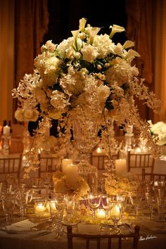 an elegant centerpiece with candles and flowers