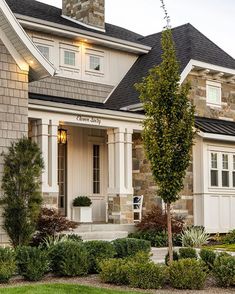 the front of a house with landscaping around it