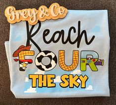 a white t - shirt that says beach four the sky with cartoon characters on it