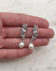 Feminine & modern, our Tate Pearl & CZ Earrings are crafted with no shortage of sparkle. Shimmering CZ stones are designed to perfectly sit along your ear with a delicate freshwater pearl drop. Cubic zirconia & freshwater pearls Beauty & dimension of freshwater pearls come from slight variations in shape & hue Measures 1.5" length Hypoallergenic, lead-free & nickel-free Style #4284 Teardrop Cubic Zirconia Jewelry With Pearl Charm, Teardrop Pearl Charm Jewelry With Cubic Zirconia, Elegant Teardrop Pearl Earrings With Cubic Zirconia, Cubic Zirconia Pearl Drop Bridal Earrings, Pearl Drop Bridal Earrings In Cubic Zirconia, Classic Crystal Pearl Drop Earrings, Pear-shaped Cubic Zirconia Pearl Earrings For Anniversary, Pear-shaped Crystal Earrings As A Gift, Sparkling Pearl Earrings For Gift