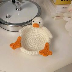 a crocheted duck sitting on top of a table