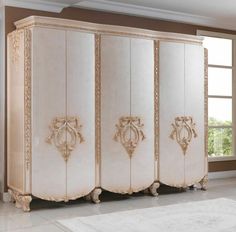 a large white cabinet sitting in a living room next to a window and rug on the floor