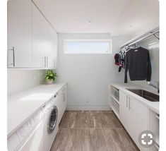 a white laundry room with washer and dryer