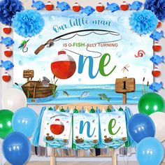 an ocean themed first birthday party with balloons and streamers on the table for one