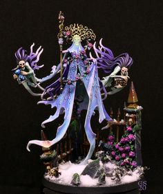 a figurine is displayed in front of a black background with purple and green decorations