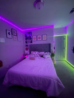 a bed with purple lights in a bedroom