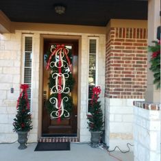 the front door is decorated with christmas decorations