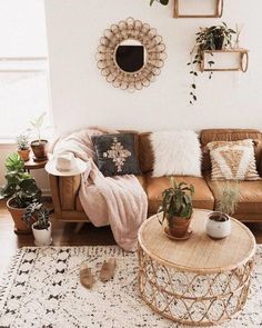 a living room filled with furniture and potted plants on top of a white rug