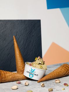 an ice cream sundae with two cones on the table