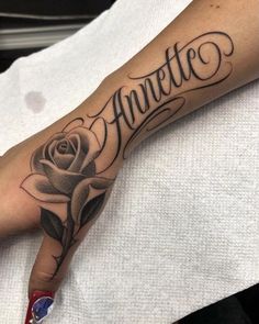 a person with a rose tattoo on their arm and the word amelie written in cursive writing