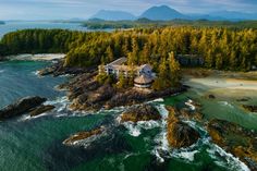 an aerial view of a house on top of a small island in the middle of the ocean