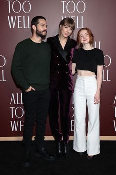 two men and a woman standing next to each other