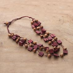 Artisans from the Indian region showcase the refined side of the forest in this three-strand necklace, presented by Rahul Jain. A palette of burgundy hues merges with natural shades in the haldu wood beads that compose this necklace—each element arranged on soft cotton threads. Burgundy And Brown, Hand Painted Necklace, Three Strand Necklace, Cotton Jewelry, Cotton Necklace, Casual Necklaces, Brown Jewelry, Painted Jewelry, Hand Painted Jewelry