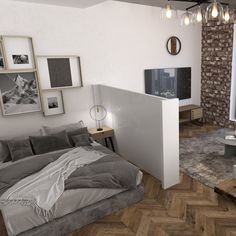 a living room with a bed, television and pictures on the wall in it's corner