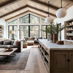 a living room filled with furniture and lots of windows