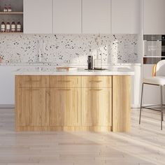 a modern kitchen with white cabinets and wood flooring