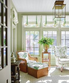 a living room filled with lots of furniture next to a window covered in sun light