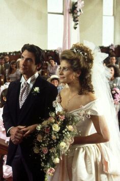 the bride and groom are walking down the aisle at their wedding ceremony in an old church