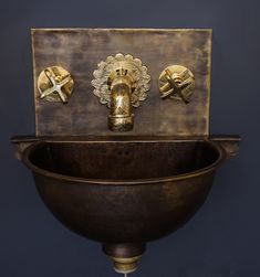 an antique sink with brass faucets and knobs