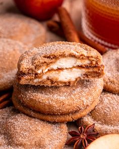 cinnamon apple cookies are stacked on top of each other with an apple in the background