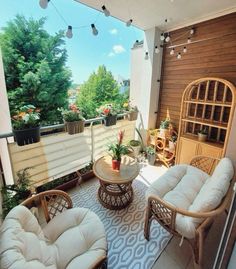 a balcony with wicker furniture and potted plants