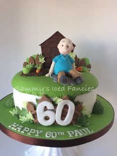 a birthday cake for someone's 60th birthday with a small boy sitting on top