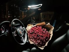 the interior of a car with a bunch of flowers in it's center console