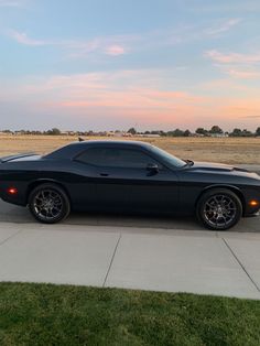 a black sports car parked on the side of the road