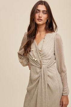 -Color: Silver -Wrap style long sleeve glittered maxi dress -V-neck -Long puff sleeves with elastic cuffs -Zipper on center back -Lined -Content: 100% Polyester -Imported -Model is 5' 7" 31-24-35 and wearing a size Small V-neck Maxi Dress With Elastic Sleeves For Party, Elegant Lantern Sleeve Maxi Dress For Party, Chic Lantern Sleeve Maxi Dress For Party, Long Sleeve Shimmer Dress For Date Night, Spring Party Maxi Dress With Blouson Sleeves, Party Maxi Dress With Elastic Sleeves And V-neck, Chic Maxi Dress With Puff Sleeves For Party, Long Sleeve Shimmer Dress For Spring, Party Maxi Dress With Balloon Gathered Sleeves