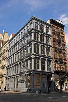 an old building with fire escapes in the middle of it's front and side