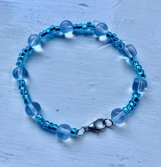 A nice light blue bracelet Adjustable Beaded Aquamarine Bracelets, Light Blue Bangle Jewelry Gift, Light Blue Bangle Jewelry For Gift, Handmade Light Blue Aquamarine Bracelets, Handmade Light Blue Crystal Bracelet With Round Beads, Handmade Adjustable Aquamarine Bracelet, Elegant Blue Aquamarine Bracelets, Blue Beaded Crystal Bangle Bracelet, Blue Aquamarine Bracelets As Gift