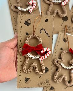 handmade gingerbread man ornament with red bow and white beads on brown card