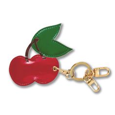 an apple shaped keychain with a green leaf on the top and a red apple on the bottom