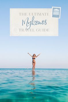 a woman standing in the water with her arms spread out and hands raised above her head